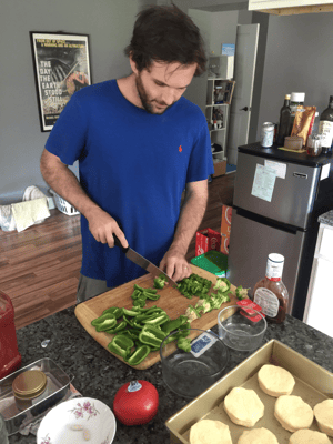 Ronnie shows off his chopping skills as he prepares green peppers from his garden.