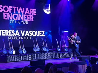 Photo of Dr. Teresa Vasquez accepting her Guitar Award for Software Engineer of the Year at the NTC Awards via the NTC's Twitter. 